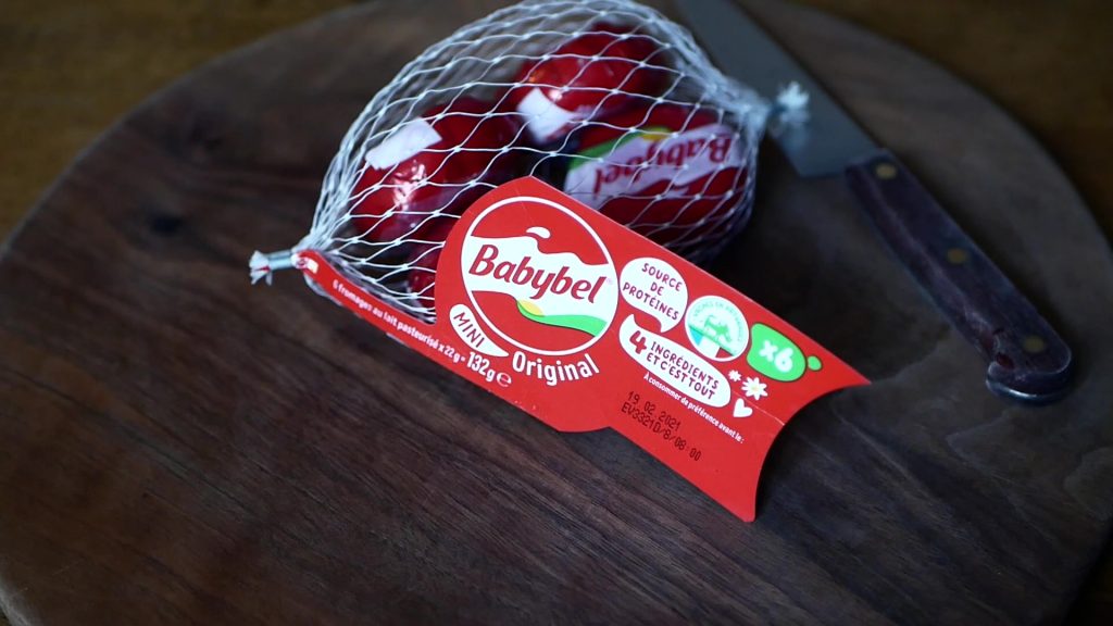 a bag with six pieces of red mini babybel cheese